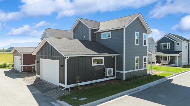 view of side of property featuring a mountain view, ac unit, and a lawn