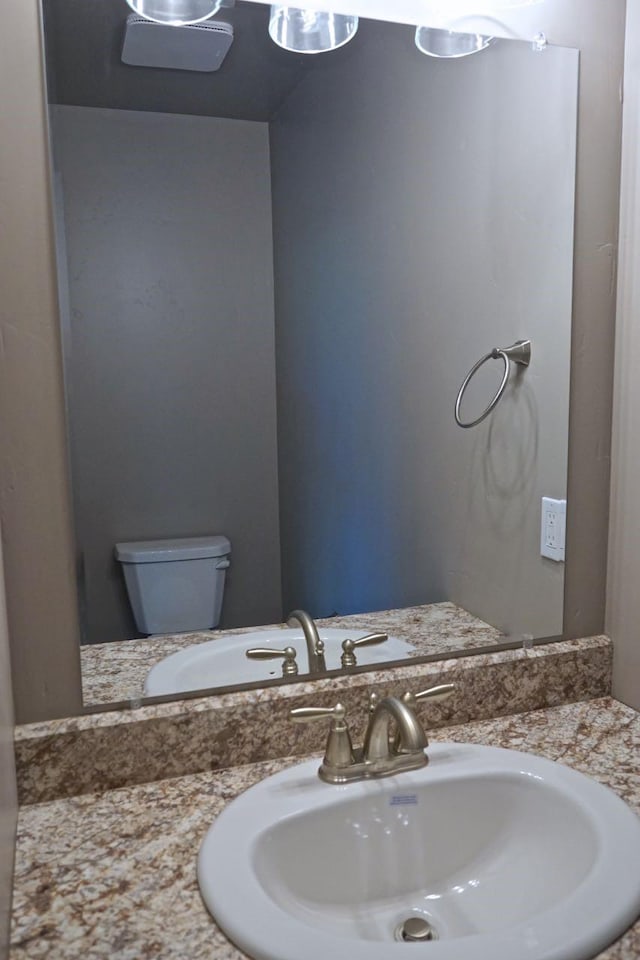 bathroom featuring toilet and vanity