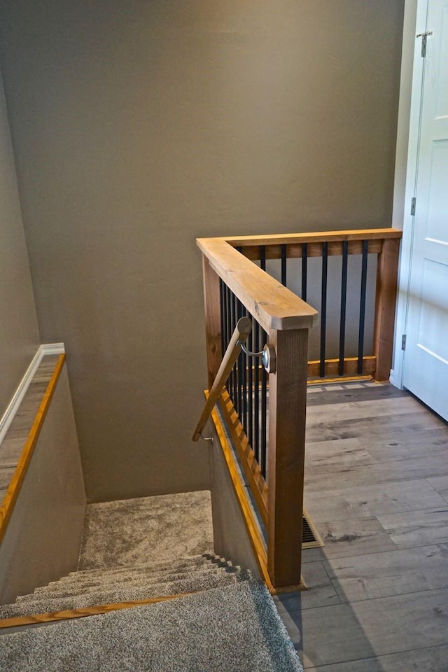 staircase featuring wood finished floors