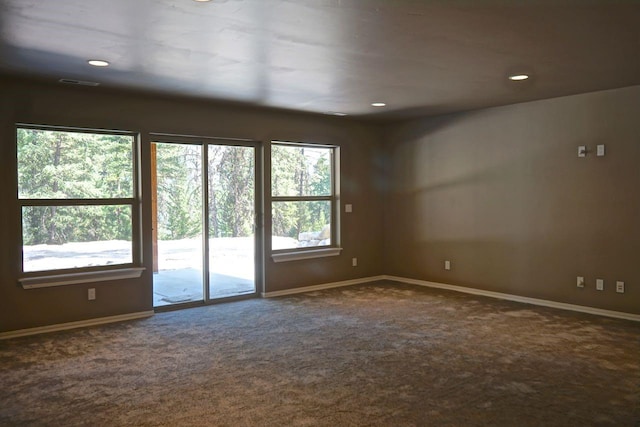 spare room with recessed lighting, carpet flooring, visible vents, and baseboards