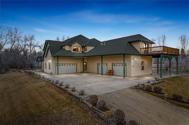 view of front facade featuring a garage and a wooden deck