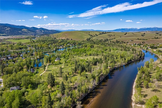 drone / aerial view with a water and mountain view