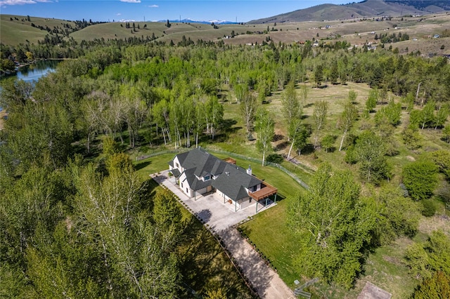 drone / aerial view with a water and mountain view