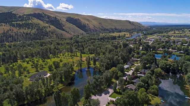 drone / aerial view featuring a water and mountain view