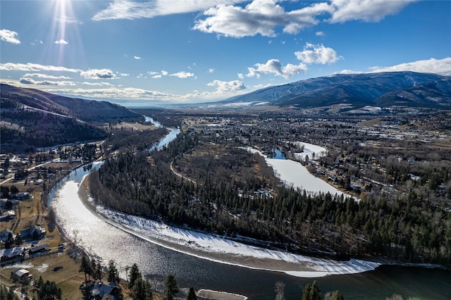 drone / aerial view featuring a water and mountain view