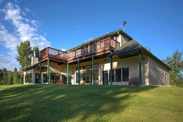 rear view of property featuring a yard and a wooden deck