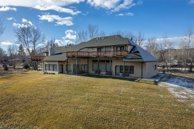 back of house featuring a lawn and a wooden deck