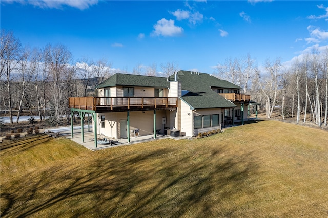 rear view of house featuring a lawn, a patio area, central AC unit, and a deck