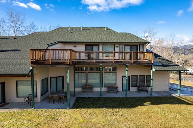 back of house with a lawn, a patio area, and a deck