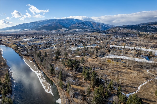 birds eye view of property with a water and mountain view