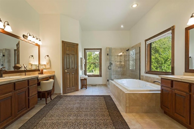 bathroom featuring plus walk in shower, vanity, and tile patterned floors