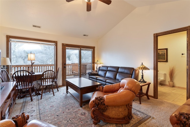 living room featuring light tile patterned floors, ceiling fan, and lofted ceiling