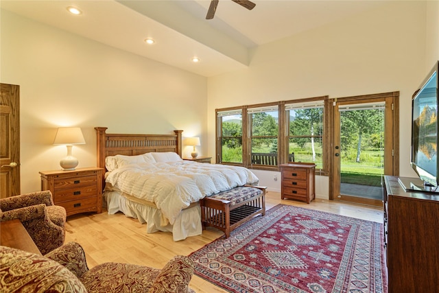 bedroom featuring a high ceiling, access to outside, light hardwood / wood-style flooring, and ceiling fan