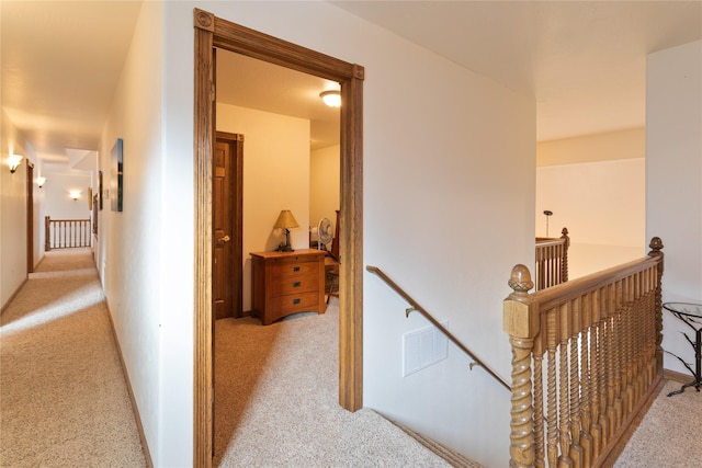 corridor featuring light colored carpet