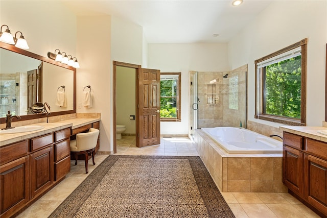 full bathroom with shower with separate bathtub, vanity, toilet, and tile patterned floors