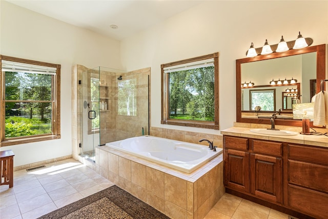 bathroom with tile patterned floors, vanity, and independent shower and bath