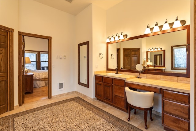 bathroom with tile patterned floors, vanity, and plenty of natural light