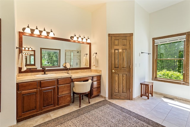 bathroom with vanity, tile patterned floors, an enclosed shower, and a healthy amount of sunlight