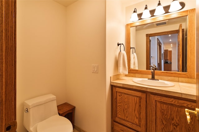 bathroom with vanity and toilet