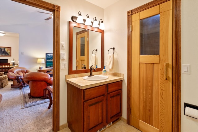 bathroom with tile patterned flooring, vanity, and ceiling fan