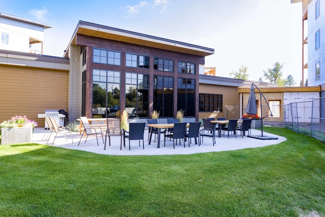 back of house with a lawn and a patio area