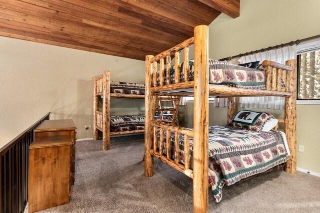 carpeted bedroom with lofted ceiling, wood ceiling, and wooden walls