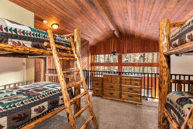 carpeted bedroom featuring vaulted ceiling with beams and wooden ceiling