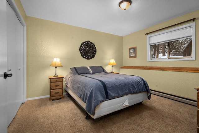 bedroom with a closet and a baseboard radiator