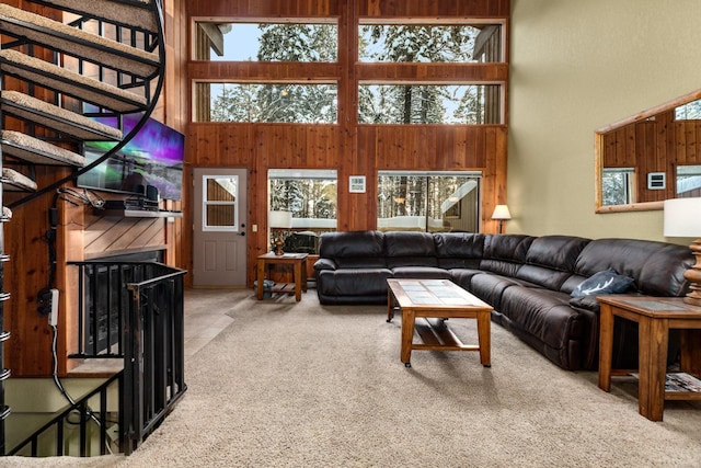 105 Cedar Way Unit 105, Whitefish, MT 59937 - carpeted living room featuring healthy amount of natural light, a towering ceiling, and wood walls