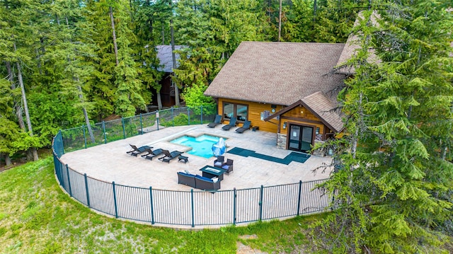 view of pool with french doors, an outdoor living space, and a patio area