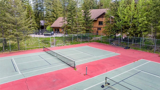 view of tennis court with basketball hoop