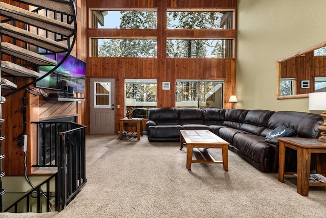 carpeted living room with a towering ceiling