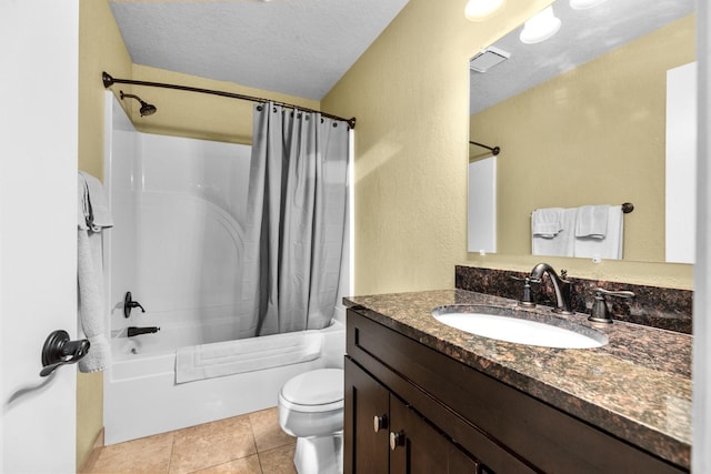 full bathroom featuring vanity, a textured ceiling, shower / tub combo with curtain, tile patterned flooring, and toilet