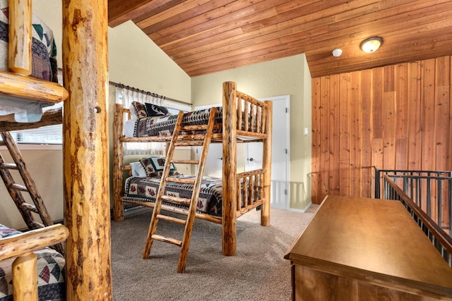 105 Cedar Way Unit 105, Whitefish, MT 59937 - bedroom with vaulted ceiling, carpet flooring, wood ceiling, and wooden walls