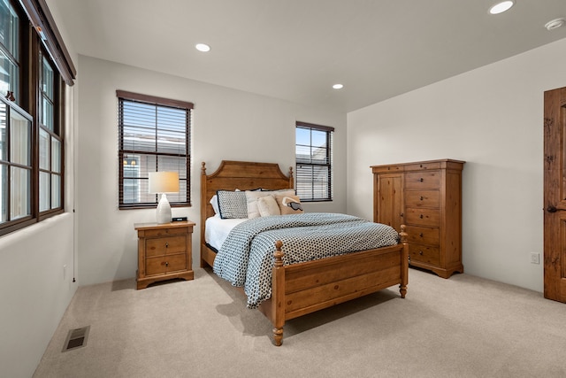 carpeted bedroom featuring multiple windows