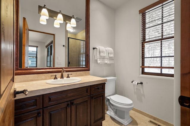 bathroom featuring toilet, vanity with extensive cabinet space, and tile flooring