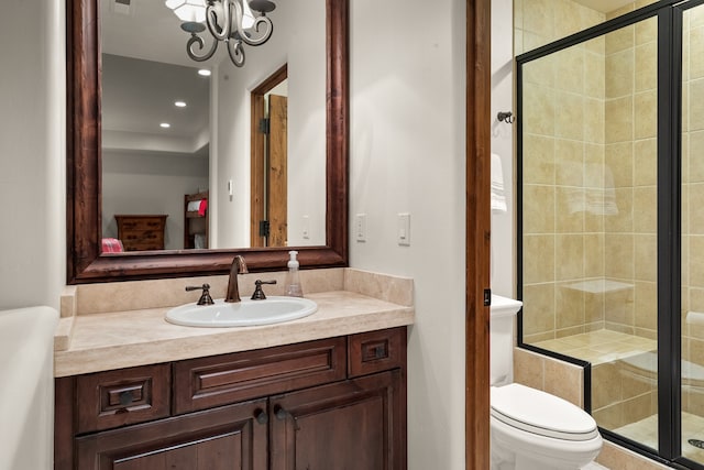 bathroom with walk in shower, toilet, vanity, and a notable chandelier