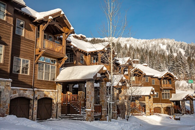 snow covered building with a garage