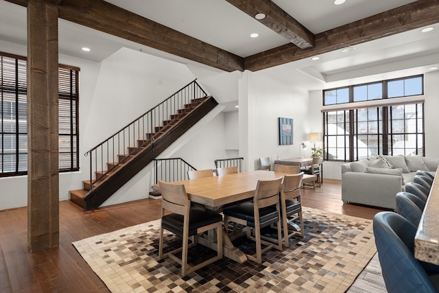 dining space with dark hardwood / wood-style flooring and beam ceiling