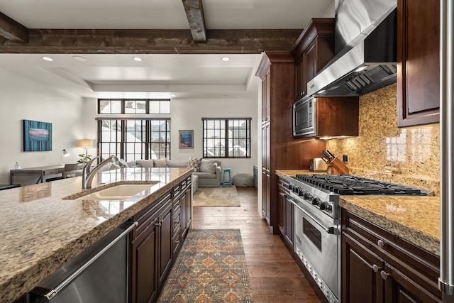 kitchen featuring appliances with stainless steel finishes, wall chimney range hood, beamed ceiling, sink, and dark hardwood / wood-style floors