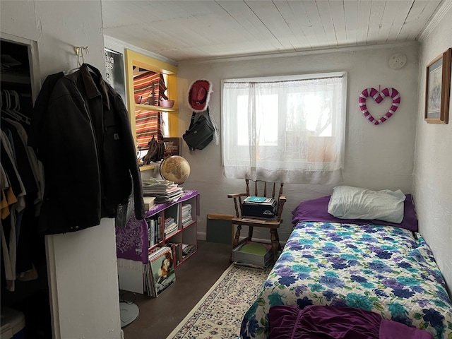 bedroom with crown molding and concrete floors