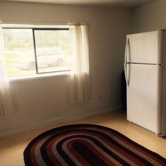 interior space featuring white refrigerator and a wealth of natural light