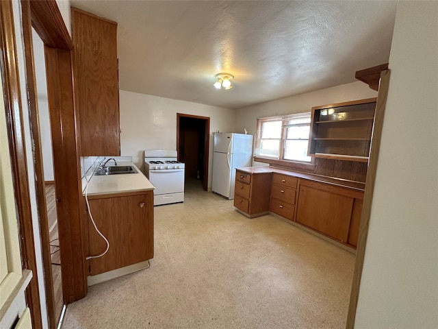 kitchen featuring white appliances and sink