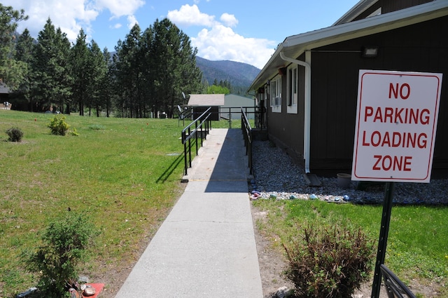 exterior space with a mountain view and a yard