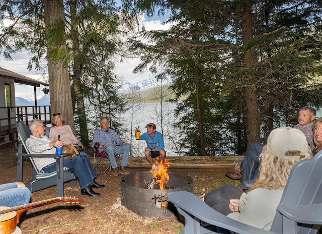 view of yard with an outdoor fire pit and a mountain view