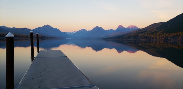 view of dock featuring a water and mountain view