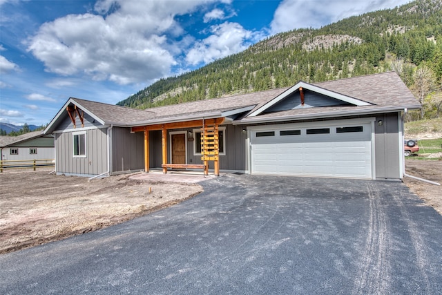 ranch-style house with a mountain view and a garage