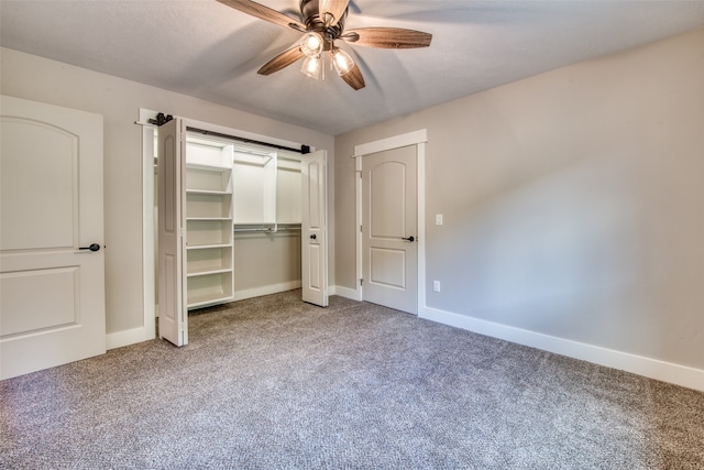 unfurnished bedroom featuring ceiling fan and carpet