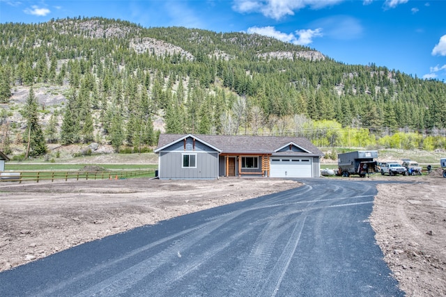 view of front of home featuring a mountain view and a garage