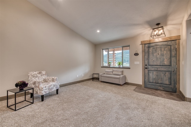 living area featuring lofted ceiling and carpet